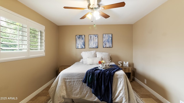 524 W Fairway Dr Unit 10, Mesa, AZ 85201 - bedroom featuring baseboards, stone tile floors, and a ceiling fan