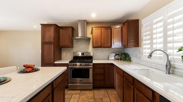 524 W Fairway Dr Unit 10, Mesa, AZ 85201 - kitchen with wall chimney exhaust hood, stainless steel gas range oven, a sink, tasteful backsplash, and recessed lighting