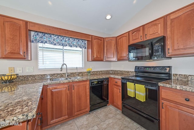 kitchen featuring sink, dark stone countertops, lofted ceiling, light tile patterned flooring, and black appliances