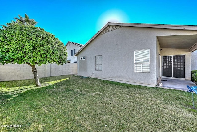 rear view of house featuring a lawn