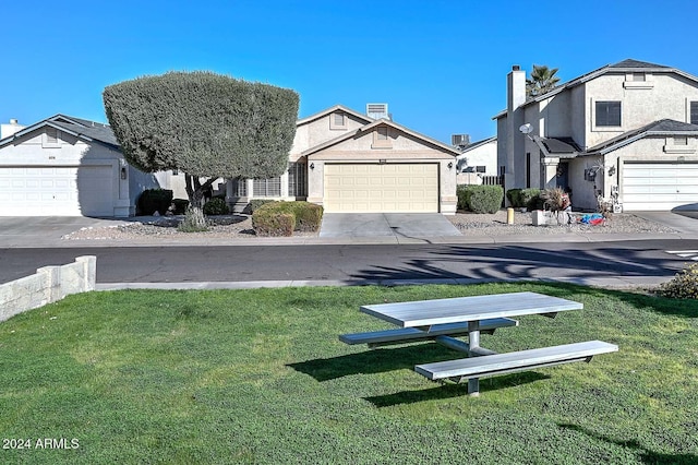 exterior space featuring a garage and a front yard