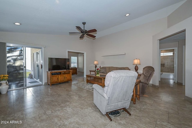 living room featuring ceiling fan, plenty of natural light, and vaulted ceiling