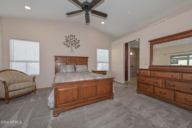 bedroom featuring ceiling fan, light colored carpet, lofted ceiling, and connected bathroom