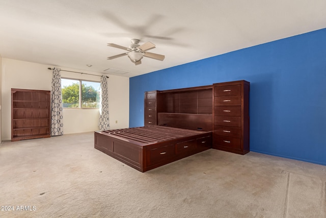 unfurnished bedroom featuring ceiling fan and light carpet