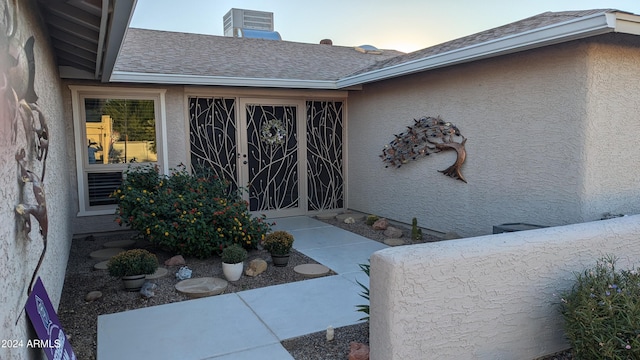 exterior entry at dusk featuring cooling unit