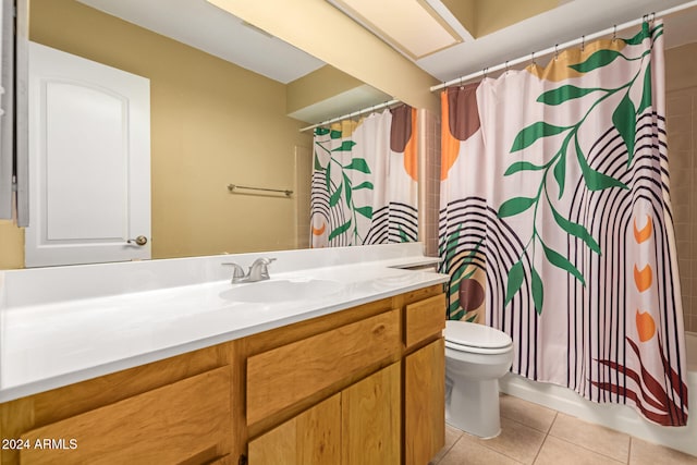 full bathroom featuring toilet, vanity, tile patterned floors, and shower / bath combo with shower curtain