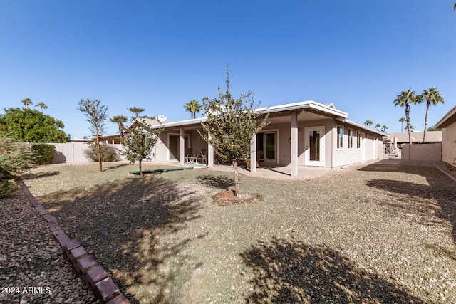 back of property with a patio