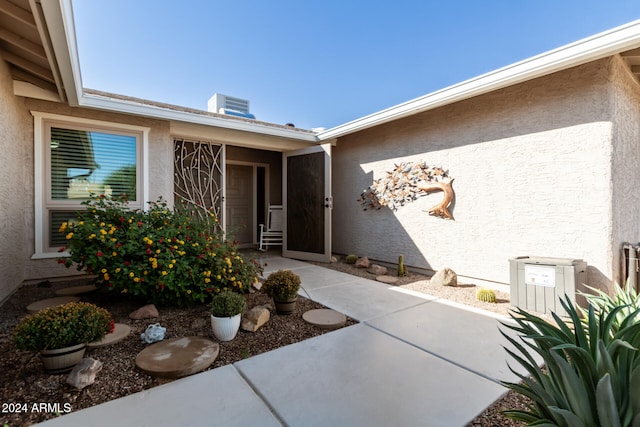 doorway to property with central AC unit