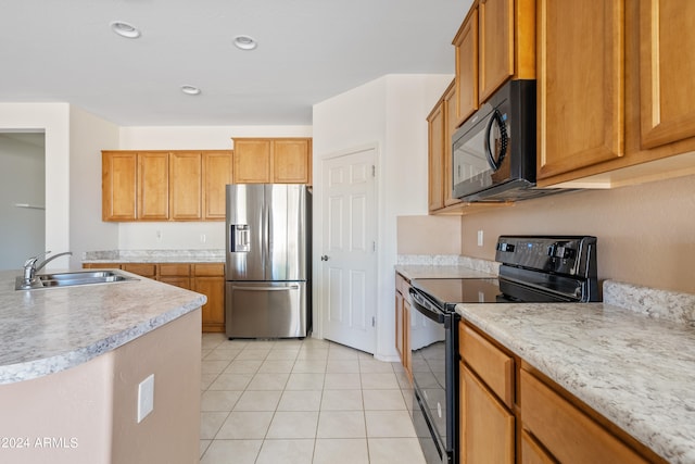 kitchen featuring sink, black appliances, and light tile patterned flooring