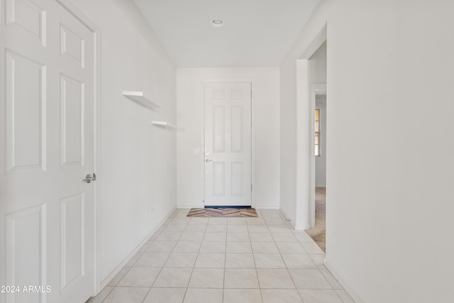 corridor featuring light tile patterned floors