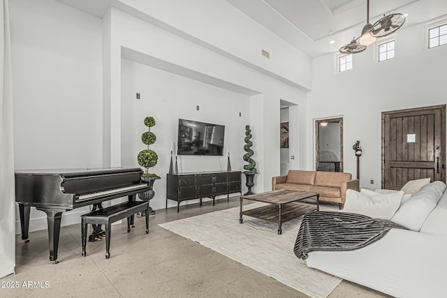 living area with a towering ceiling and visible vents