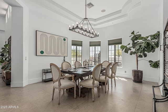 dining room with an inviting chandelier, baseboards, plenty of natural light, and visible vents