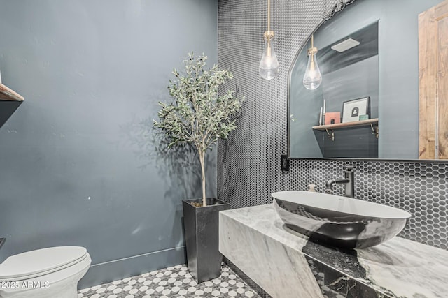 bathroom with vanity, tasteful backsplash, and toilet