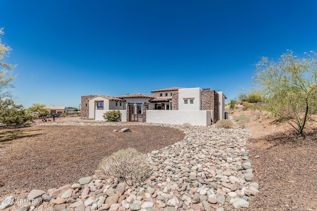 view of front of property featuring a tile roof and stucco siding