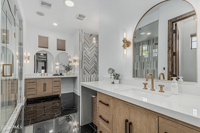 bathroom with a sink, plenty of natural light, two vanities, and visible vents
