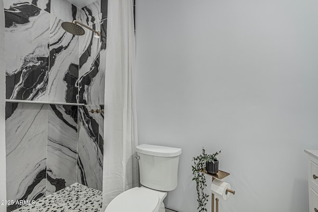 full bath featuring toilet, a marble finish shower, and vanity