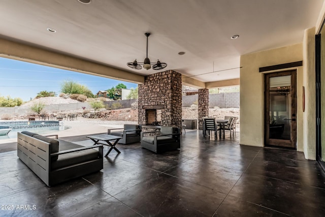view of patio with an outdoor stone fireplace, fence, and a fenced in pool