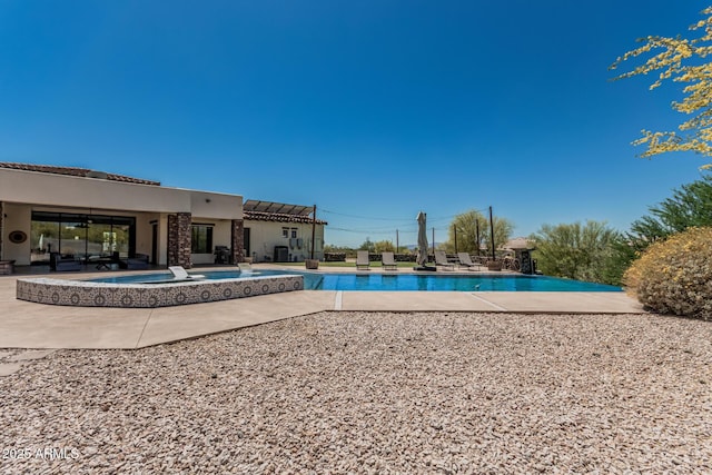 outdoor pool featuring a patio area