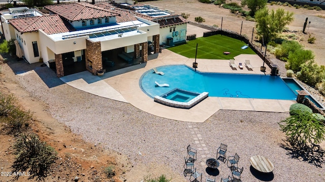 view of swimming pool with a pool with connected hot tub and a patio area