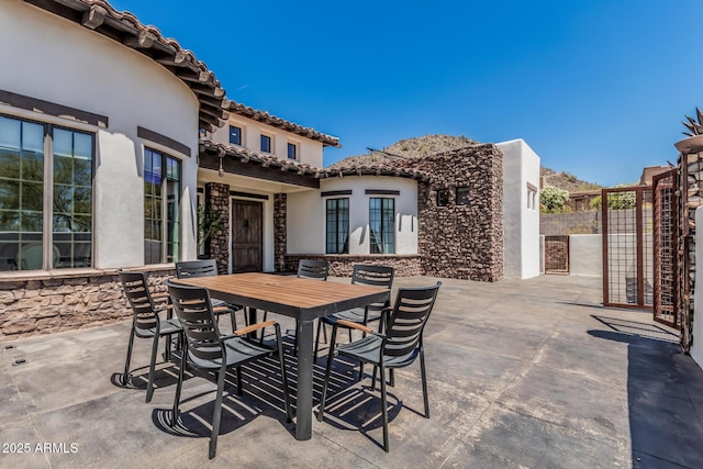 view of patio featuring fence and outdoor dining space
