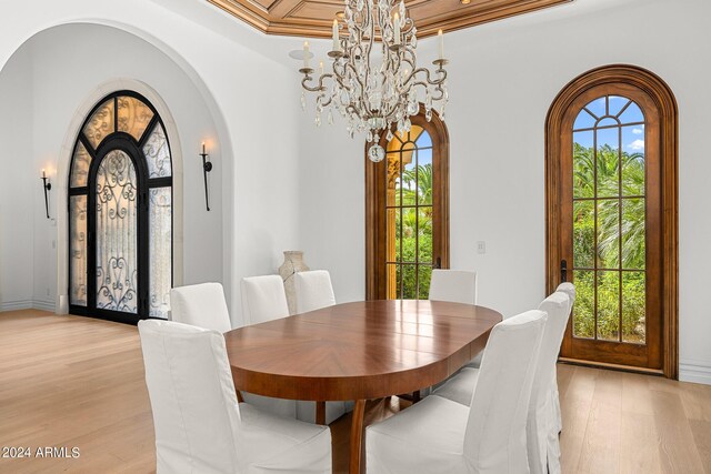 dining area featuring light wood-type flooring, an inviting chandelier, and plenty of natural light