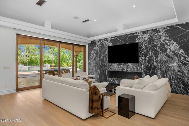 living room featuring light hardwood / wood-style flooring and a premium fireplace