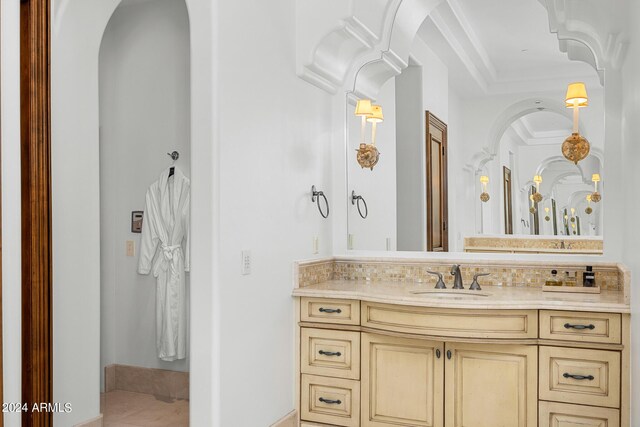 bathroom featuring ornamental molding and vanity