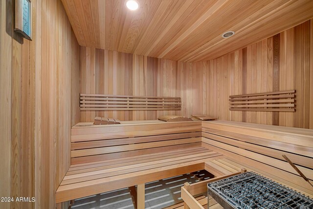 view of sauna / steam room with wooden walls and wooden ceiling