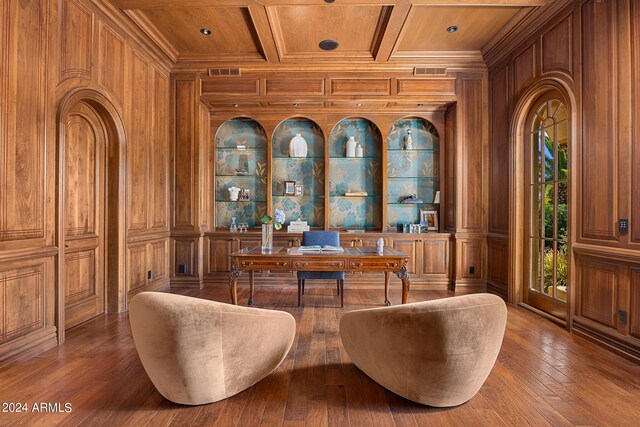 living area featuring wood-type flooring and wood walls