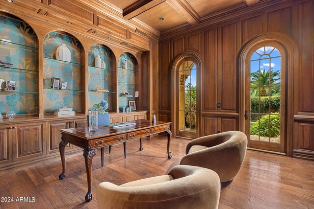 office space featuring beam ceiling, wooden walls, coffered ceiling, crown molding, and hardwood / wood-style floors