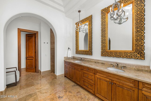 bathroom featuring an inviting chandelier and vanity