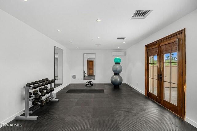 workout room with french doors and a wall mounted AC