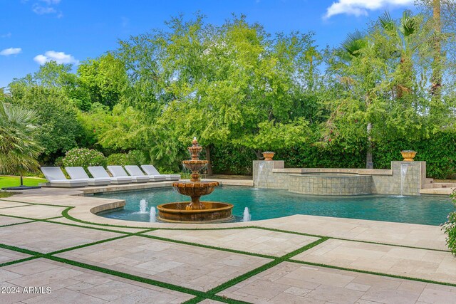 view of swimming pool featuring pool water feature and a patio area