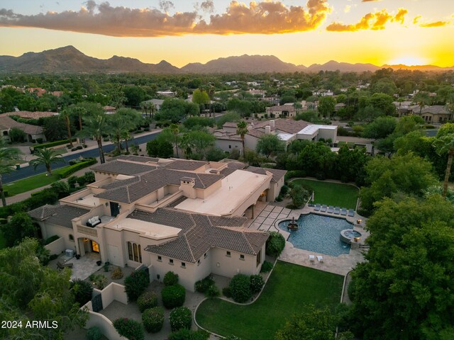 aerial view at dusk featuring a mountain view