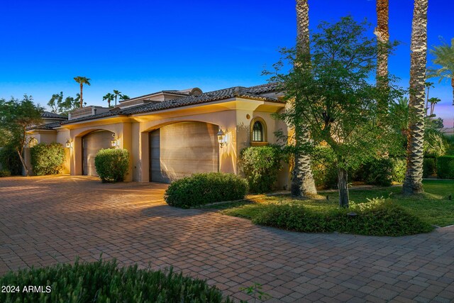 mediterranean / spanish house featuring a garage