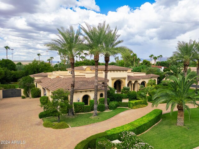 mediterranean / spanish home with a front lawn