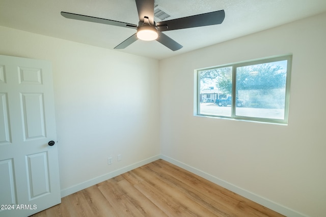 spare room featuring light hardwood / wood-style flooring and ceiling fan