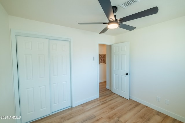 unfurnished bedroom with a closet, light wood-type flooring, and ceiling fan