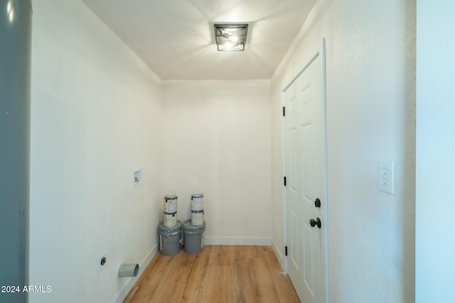 laundry area with electric dryer hookup, light hardwood / wood-style floors, and hookup for a washing machine