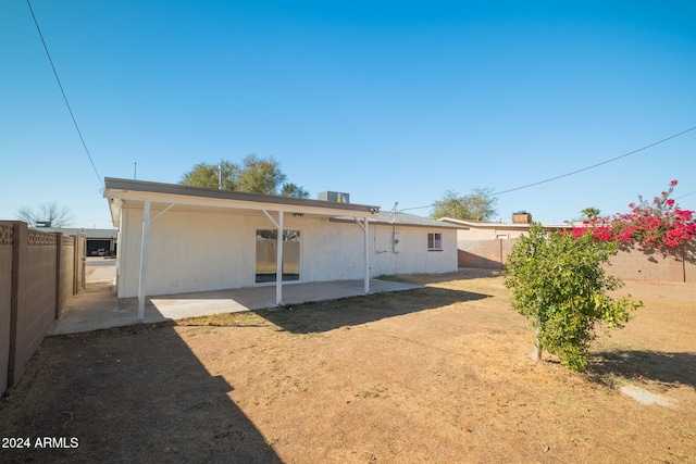 back of house with a patio