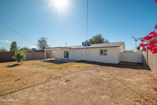 rear view of property featuring central AC and a patio area