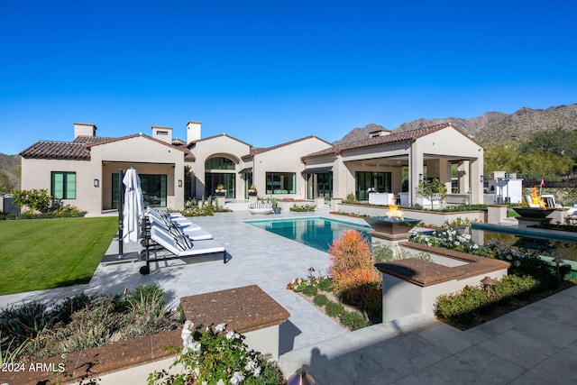 view of swimming pool with a patio area and a mountain view