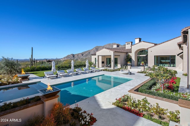 view of pool with a patio area and a mountain view