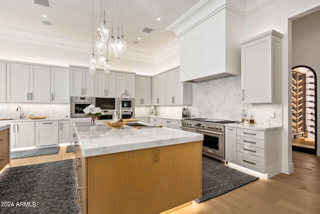 kitchen featuring backsplash, stainless steel appliances, and light stone countertops