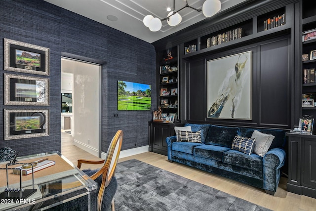 home office with a notable chandelier and light wood-type flooring