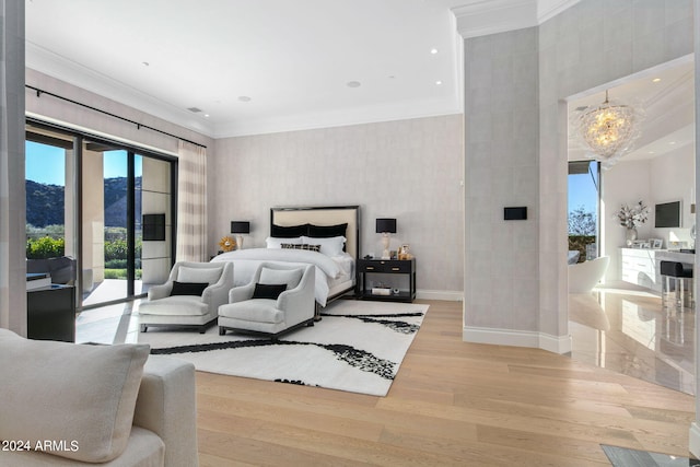 bedroom with a chandelier, ornamental molding, light hardwood / wood-style flooring, and access to exterior