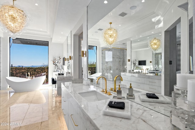 interior space featuring a washtub, vanity, a raised ceiling, a notable chandelier, and tile floors