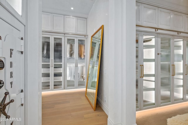 hallway with light hardwood / wood-style floors