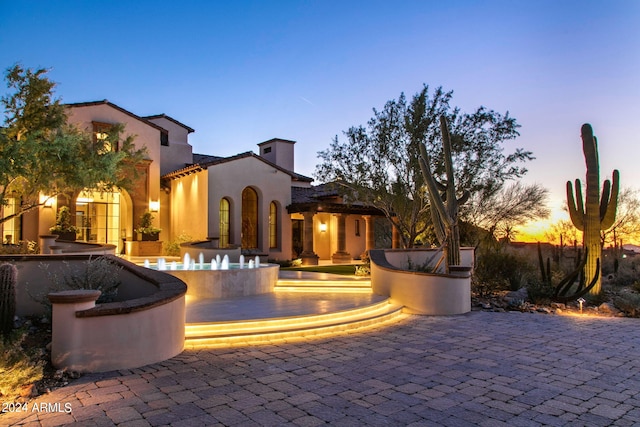 view of patio terrace at dusk