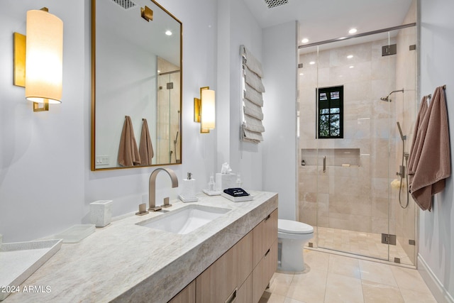 bathroom featuring walk in shower, vanity, toilet, and tile flooring